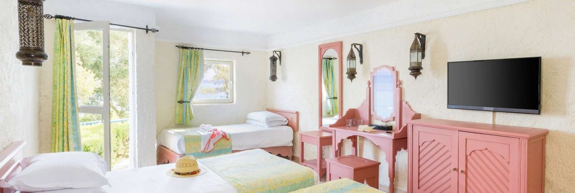 Club Med Kemer, Turkey - View of a bedroom in a brightly colored bungalow.