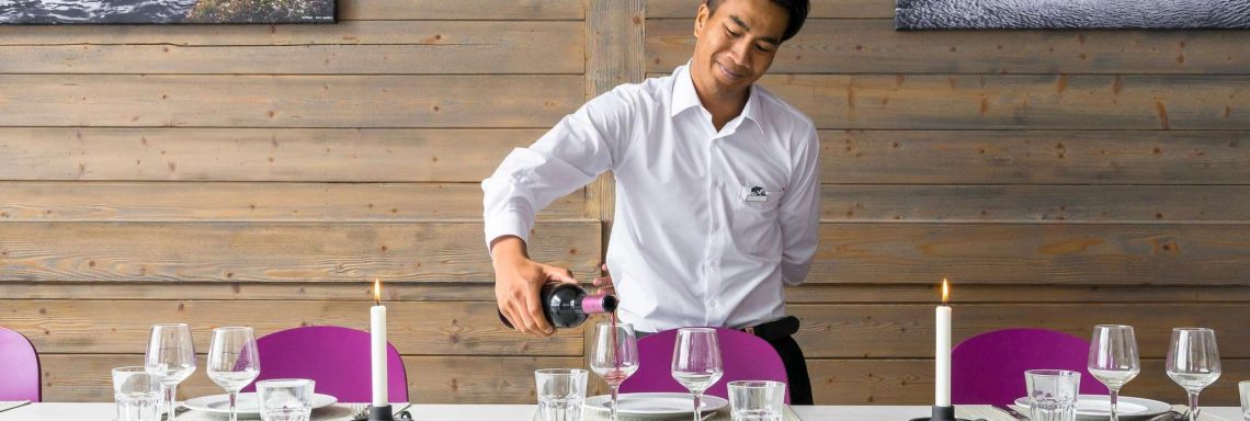 Club Med Arcs Extrême France Alps - A waiter serving wine at Le Varret restaurant