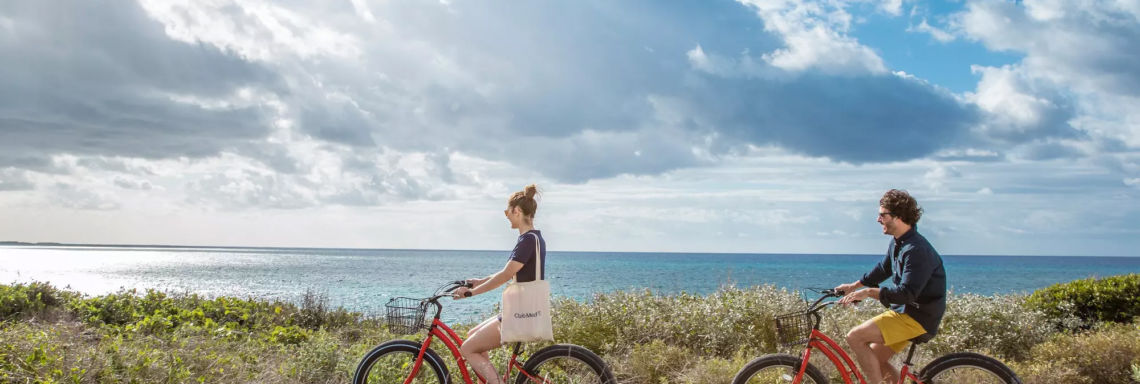 Club Med Columbus Isle, Bahamas - Couple on excursion biking on rocky edge