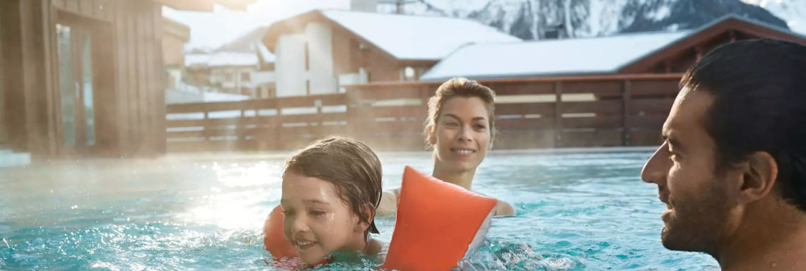 Club Med Peisey - Vallandry, France - A family enjoys the Village's heated outdoor pool